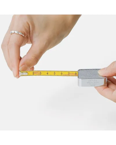 The Penco Pocket Measure has a compact shape, stainless steel body, and retro colors