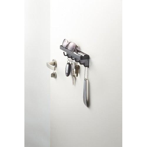 It contains many hooks for keys and has a narrow shelf on top to hold other items.